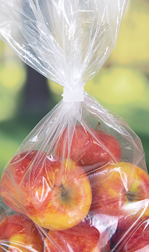 White eco friendly food packaging clip on red apple sack